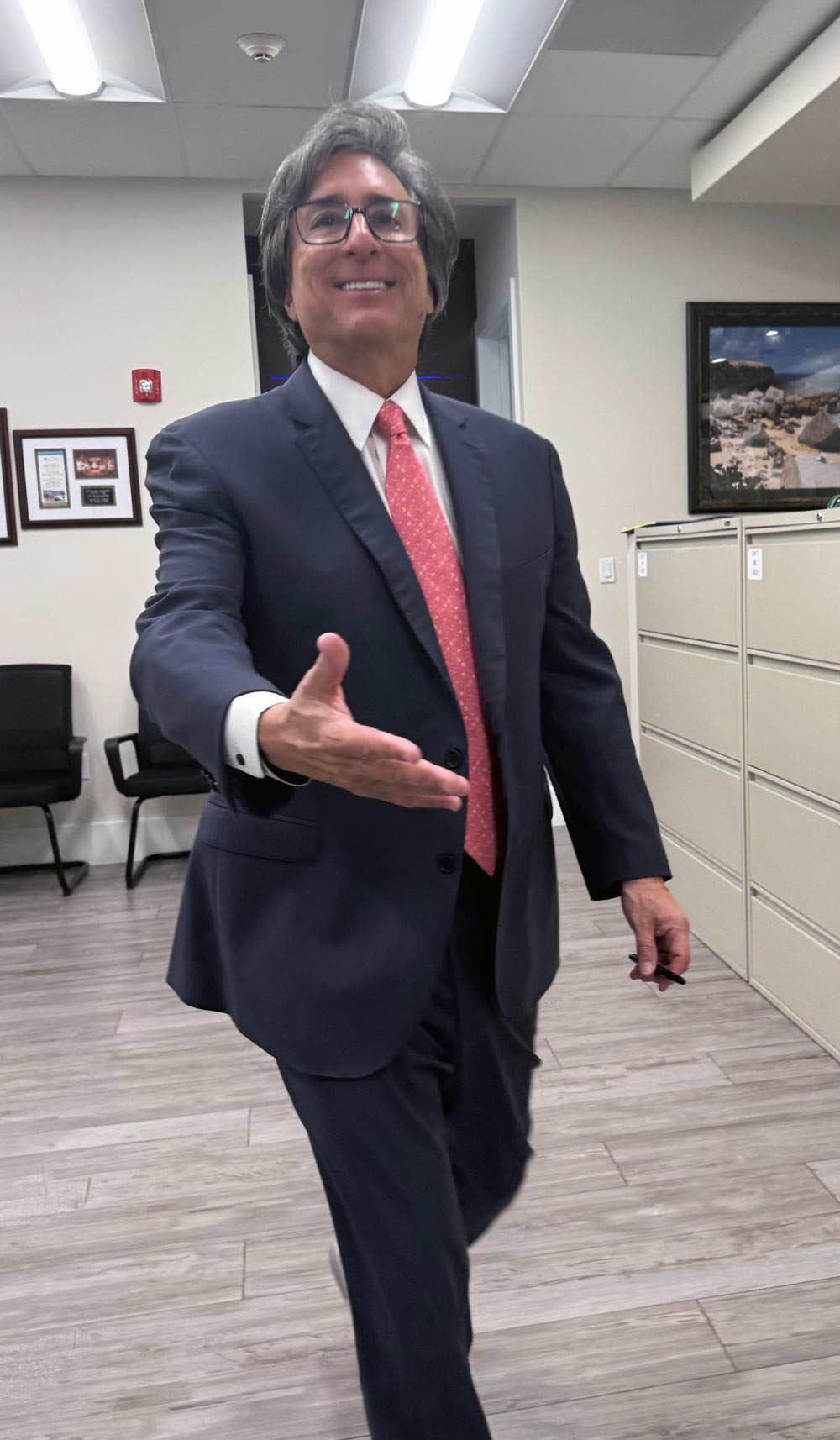 Attorney Patrick L. Cordero welcoming a client at his Miami office