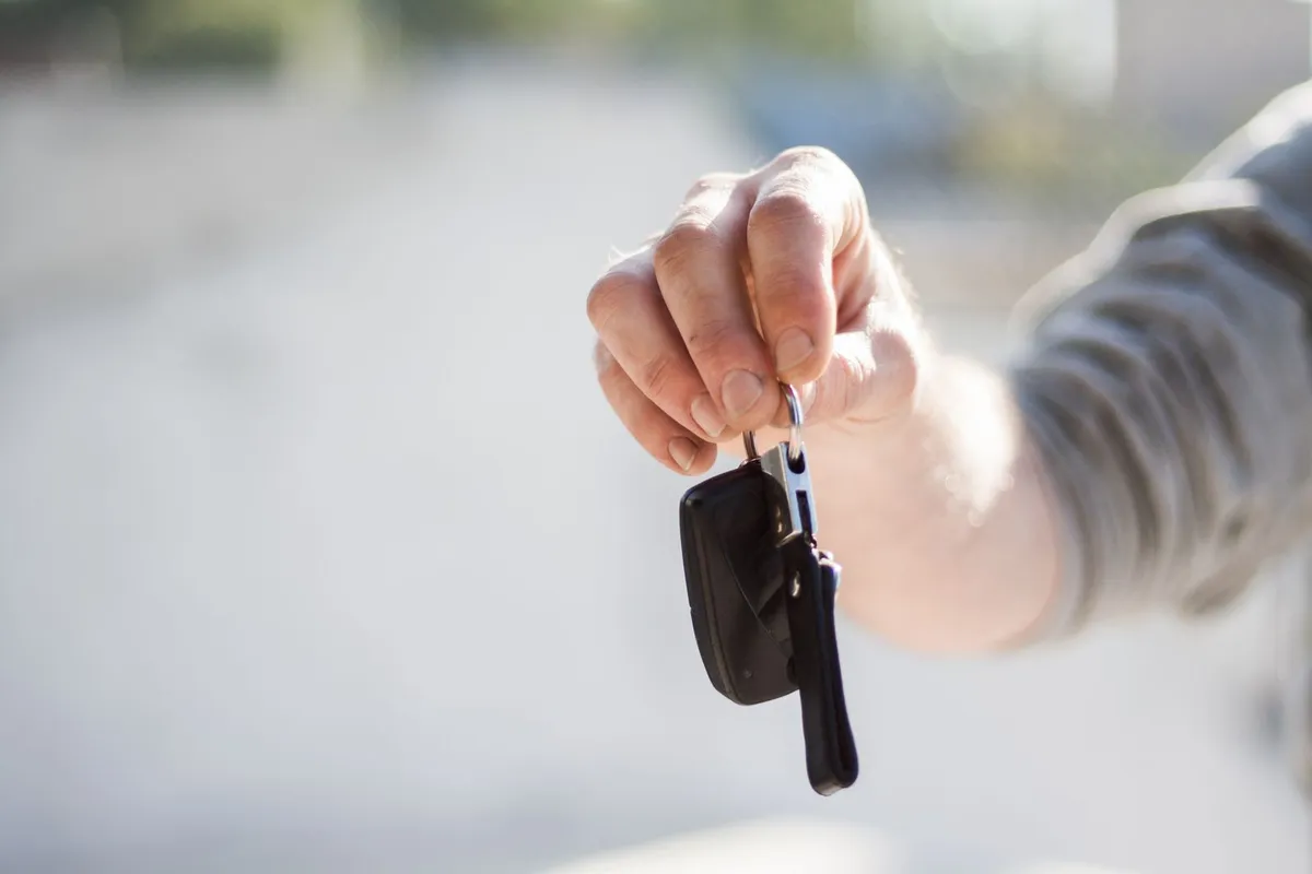 Hand holding car keys, representing keeping your vehicle in Chapter 7 bankruptcy