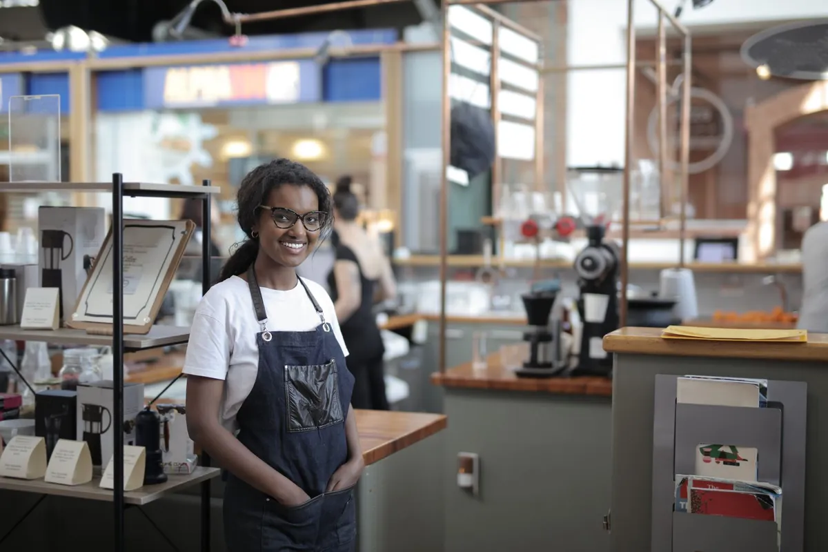 Small business owner standing in her café, weighing bankruptcy options